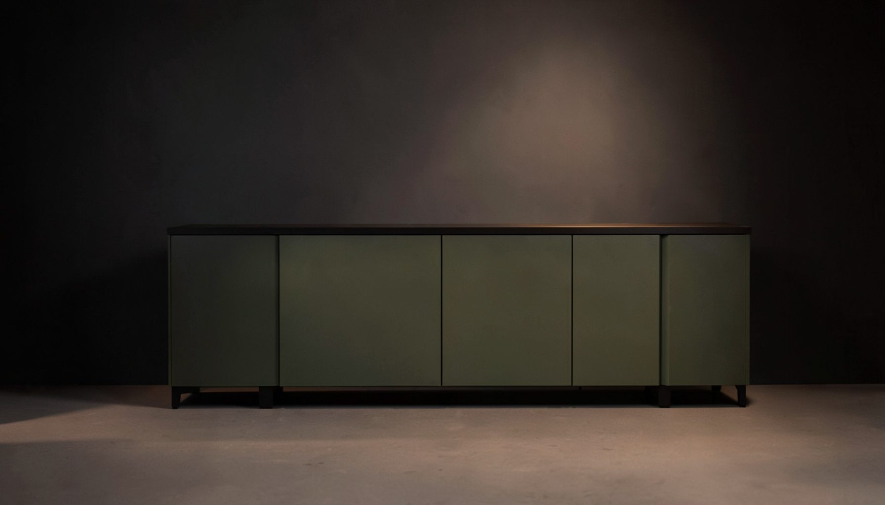 Dark charcoal and muted olive-green studio console under soft warm lighting, calm and professional broadcast atmosphere